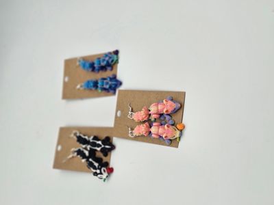 Front view of skunk earrings