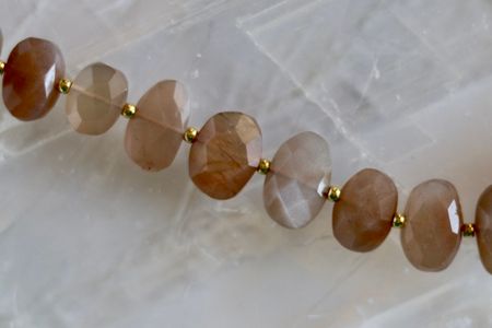 Closer look at the faceted peach moonstone beads on the Lucent Necklace