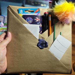 A "Mystery Coloring Adventure" wrapped in Brown Kraft paper and filled with goodies