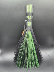 this small whisk broom was handmade with cord and broomcorn, using black and green colors, and in the "hawk's tail" style. It is perfect for functional decor in practically any room, good to prop by the fireplace, hang on the wall, or decorating an altar and using for cleansing. It is functional and beautifully crafted, handmade with love and care. (Edit Caption) (Rotate Image)