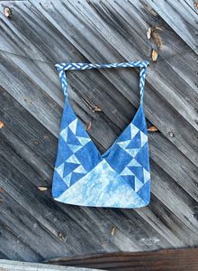 Blue and white bento style bag hanging against a wall
