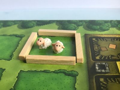 My sheep pictured on the Agricola game board. But really these look great with any game that has a sheep or wool component.