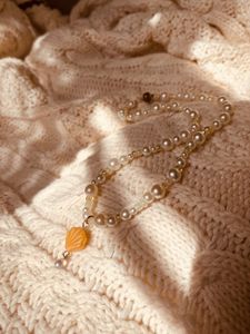 The Buttercream Pearl Shell necklace in sunlight
