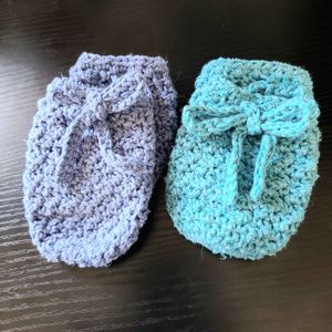 Two pairs of baby mittens in the size 12-months, in the colors Teal (12) and Blue (08) from the Acacia yarn swatch options.