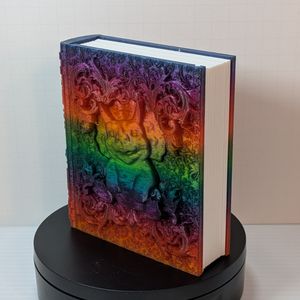 The front of the tome at an angle, showing the work on front as well as the 3D printed pages inserted. The pages are white, and they are slightly uneven so it just doesn't look like a white block of plastic.