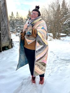 Me from the front with Polychrome wrapped around me, laughing with my eyes closed