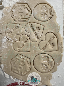Dough that has been cut/stamped with the cookie cutters