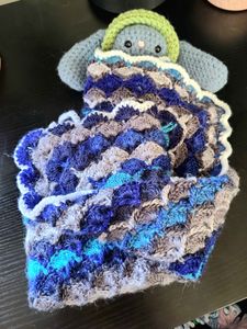 Crocheted bunny not included in order! I just thought he would look cute as an example baby for the blanket. 