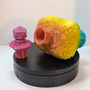 The 3D printed healing potion bottle laying on its side, showing the stopper sitting beside it. It is a threaded screw top piece.