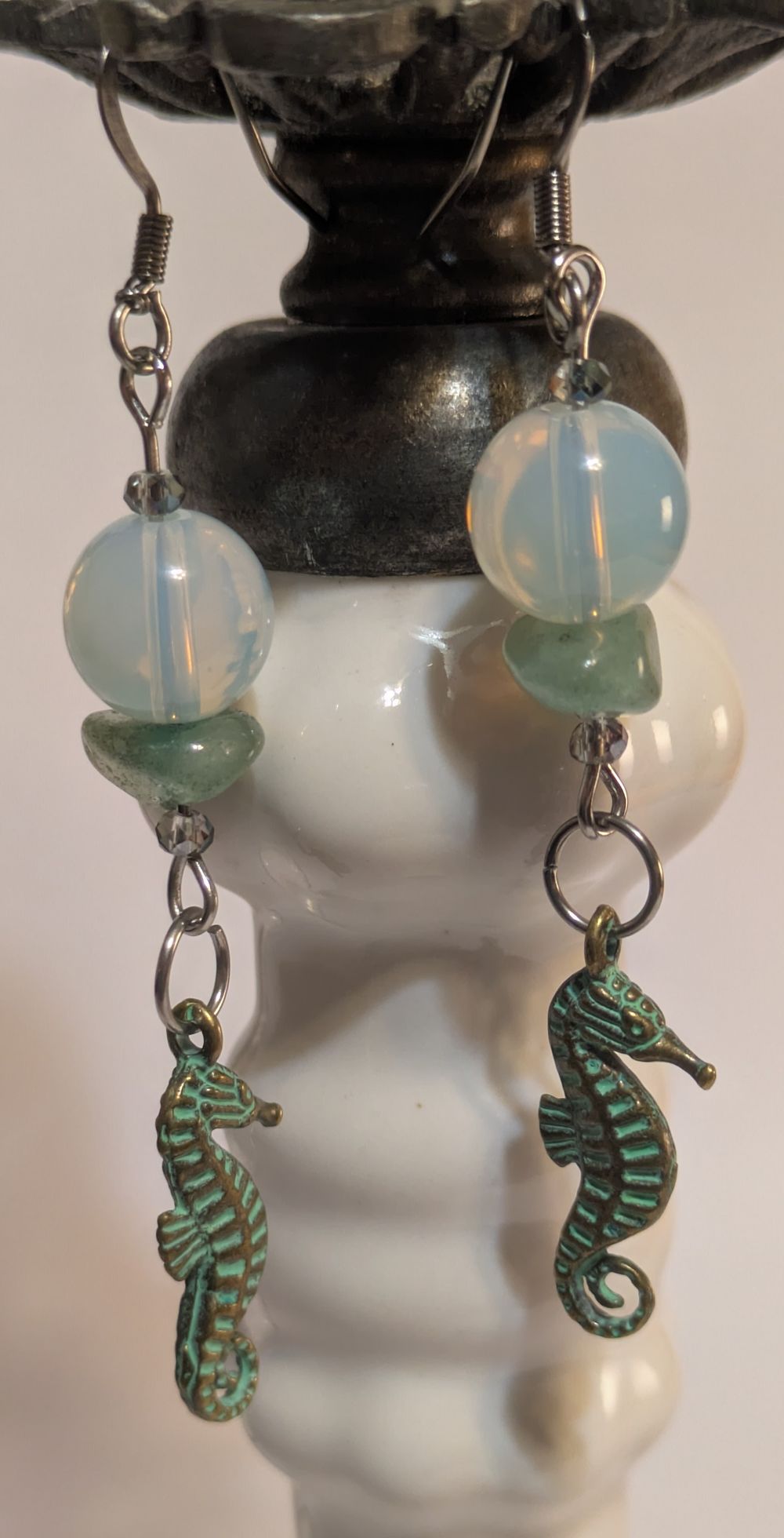 Seahorse earrings with translucent blue bead accent