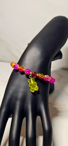Pink and yellow beads paired with a gummy bear that compliments the bracelet.