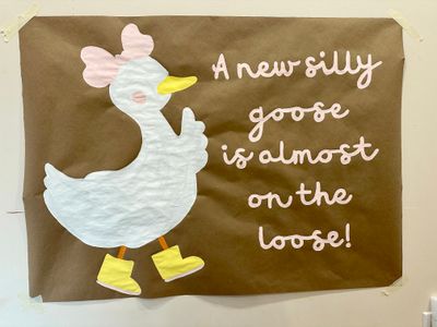 A new silly goose is almost on the loose baby shower banner with a cartoon painting of a goose wearing boots. Painting in progress