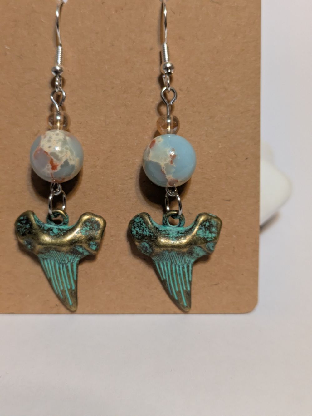 Shark teeth earrings with blue bead accent
