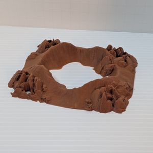 The dice catch tray the rocket rests on, printed out of a brown filament.