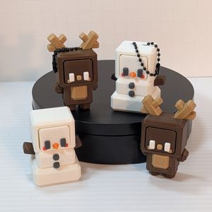 Four squarish character fidget clickers. One is a brown reindeer, the other a snowman. They have separate faces you press, and they click, with cubic heads, bodys, arms, and feet.