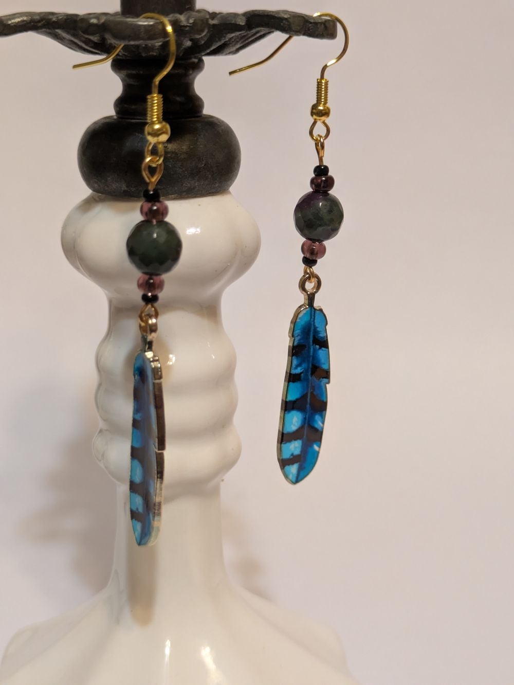 Blue bird enamel feather earrings with dark purple/green bead accents