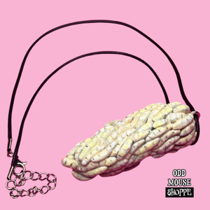 A side view of the sculpted necklace, each maggot is individually added one by one