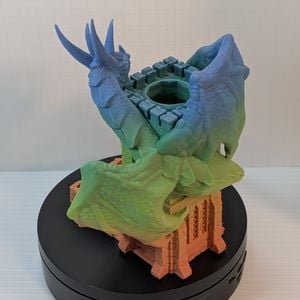 The back of the 3D printed wyvern dice tower. It shows the back plates of the creature, and the circular hole at the top for the dice to drop into.
